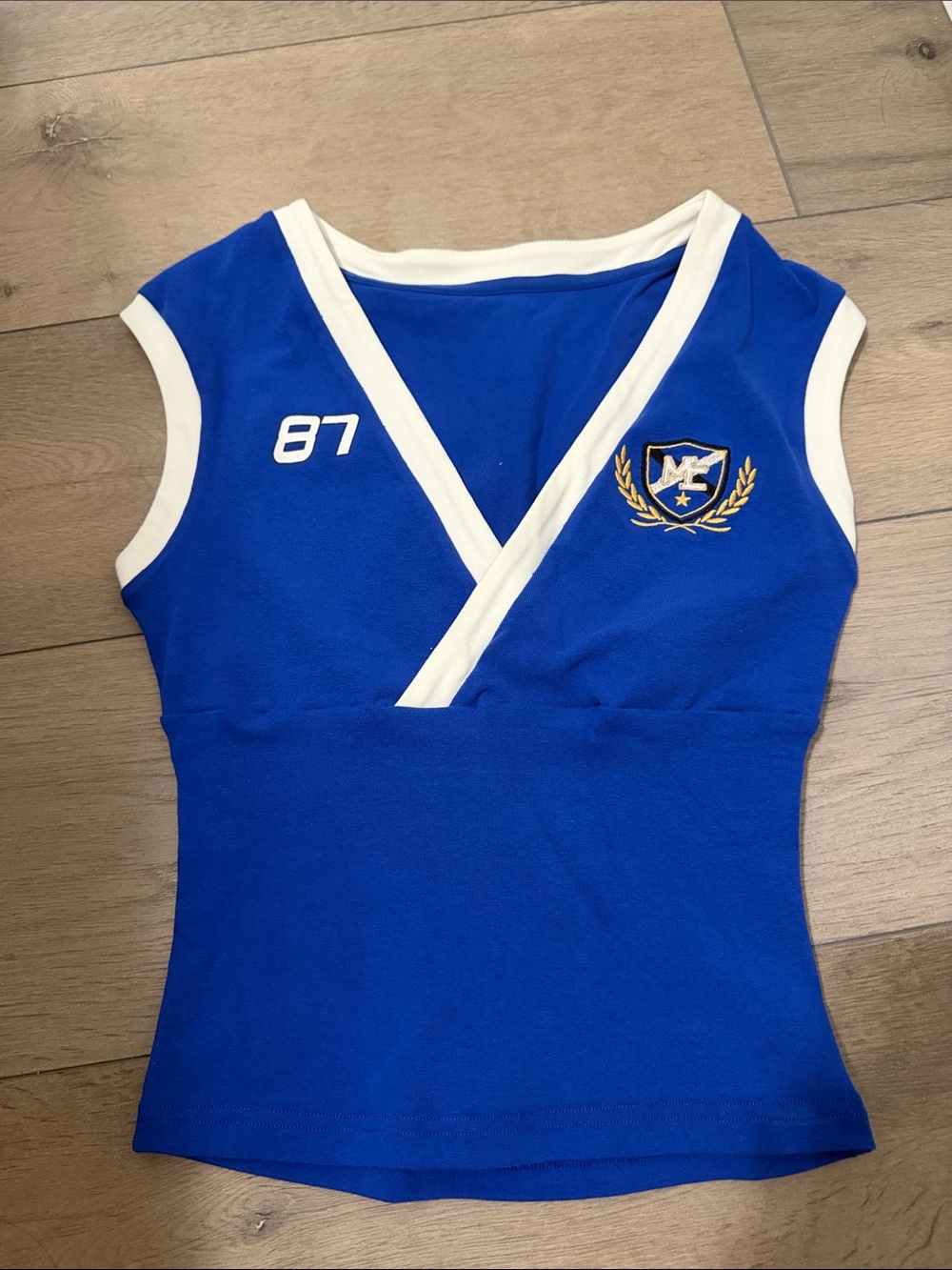Blue Sleeveless V-Neck Top with White Trim and Crest